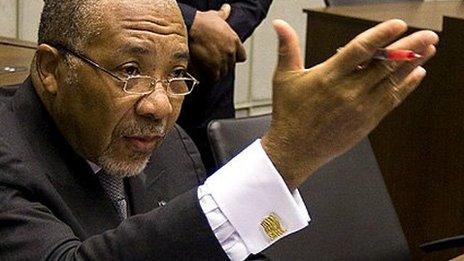 Former Liberian President Charles Taylor (L) waits on 8 February 2011 for the start of the prosecution's closing arguments during his trial at the UN Special Court for Sierra Leone