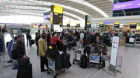 Passengers queuing at Heathrow airport