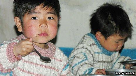 North Korean boys eat lunch in a government-run nursery