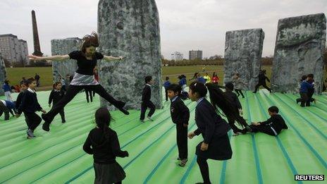 Children play on the inflatable Stonehenge