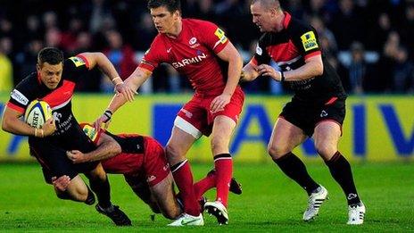 Falcons player Jimmy Gopperth is tackled by Charlie Hodgson and Owen Farrell during the Aviva Premiership match between Newcastle Falcons and Saracens