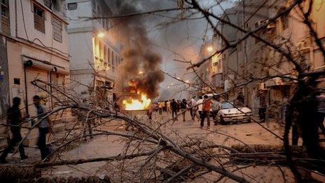 Anti-government protesters clash with riot police in a Shia suburb of Manama, 20 April 2012