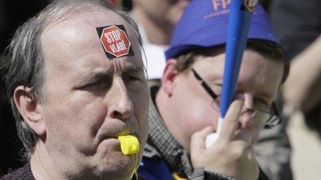 Protesters with stickers "Stop the government" blow whistles in Prague