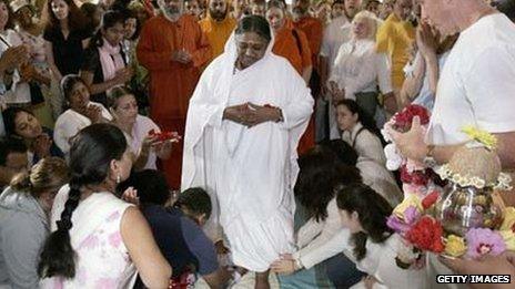 Sri Mata Amritanandamayi Dev, the hugging saint known as "Amma" (mother) has her feet washed before she begins embracing followers