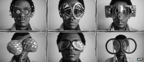 Kenyan artist Cyrus Kabiru posing with artwork resembling sunglasses on February 1, 2012 in Nairobi