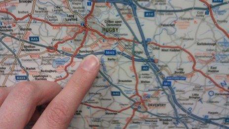 Finger pointing at a map