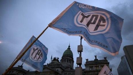 Supporters of an oil nationalization bill proposed by Argentina's President Cristina Fernandez holds up flags reading in Spanish "Fight and return YPF" outside Congress