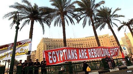 A banner in Tahrir Square reads 'Egyptians are rebuilding Egypt'