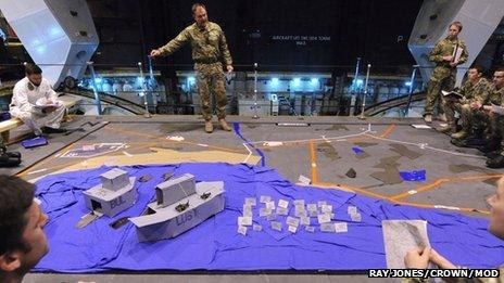 Drill using cardboard boats onboard HMS Illustrious
