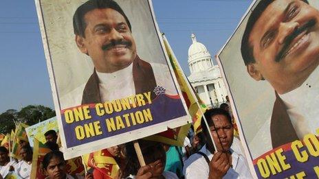 Sri Lankans carry posters of President Mahinda Rajapaksa at a rally opposing the UN Human Rights Council vote against the country - 22 March 2012