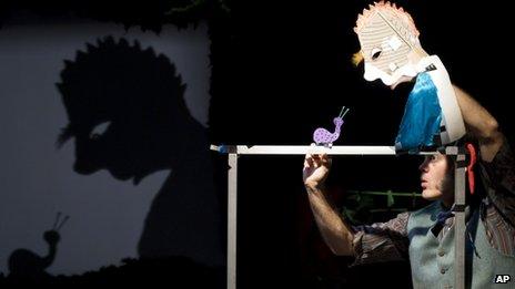 Canadian performance artist, Jeff Achtem, performs Swamp Juice, the show which features over 60 shadow puppets which include snails, mice and a swamp monster, at the Soho Theatre, London, Tuesday, April 17, 2012