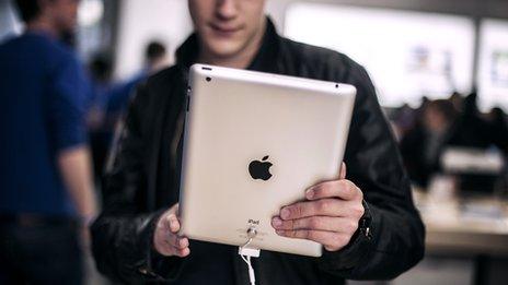 A man holds the latest Apple iPad