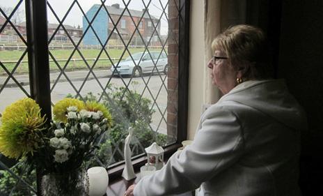 Maureen Walsh looks out of her window