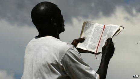 A man in Malawi reads from a bible