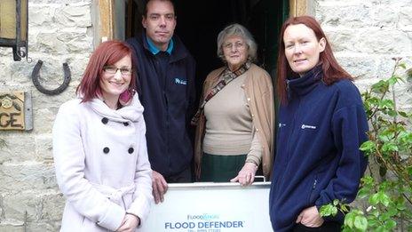 Flood barriers being installed at homes in Pickering, North Yorkshire. Michelle Lanaghan (Ryedale District Council) Gerard Sexton (Flood Barriers) Mary Croot (resident) Rachel Glossop (Environment Agency).