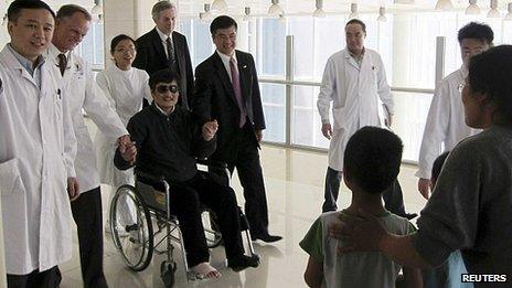 Blind activist Chen Guangcheng (in wheelchair) meets wife and children in Beijing hospital after leaving US embassy