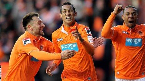 Tom Ince (c) celebrates Blackpool's opening goal after his shot is deflected into the net off Curtis Davies