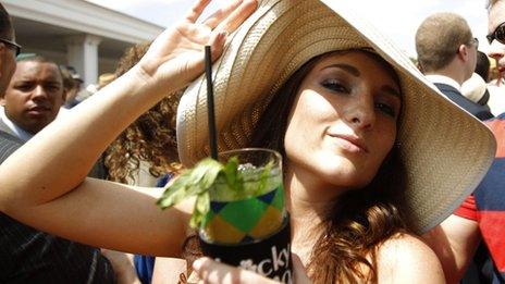 A race fan has a mint julep before the 138th running of the Kentucky Derby