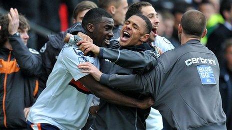 Luton players celebrate at the Racecourse Ground