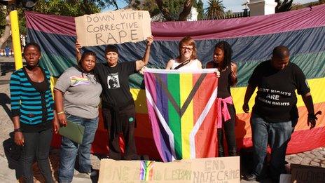 Protesters holding up a sign saying 'down with corrective rape'