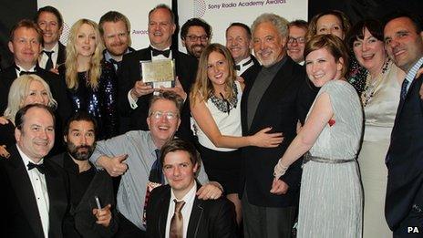 Presenters and staff of 6 Music accept the Sony Award with presenter Tom Jones