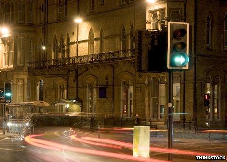 Street scene at night with traffic lights