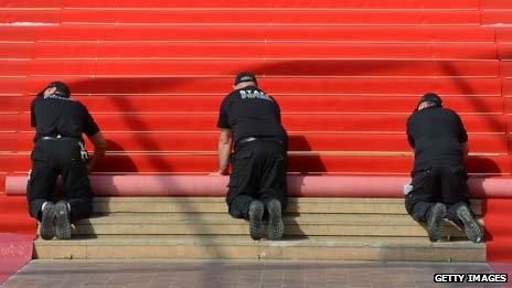 Workers unroll the red carpet in Cannes