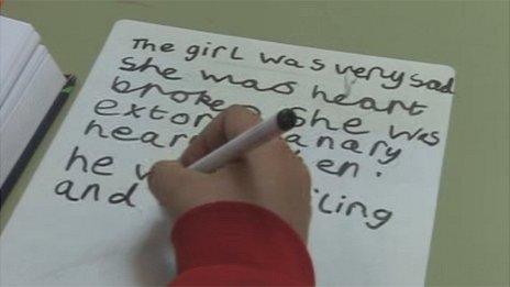 A pupil writing at Lliswerry Primary School