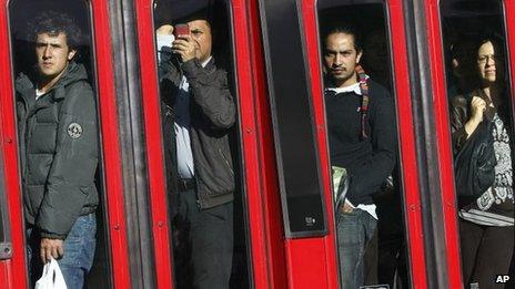 Commuters look at the site of the bomb blast in Bogota as they go past in a bus on 15 May 2012