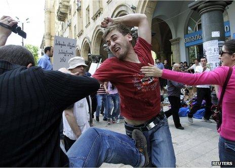 A protester (left) fights with a gay rights activist in Tbilisi, 17 May