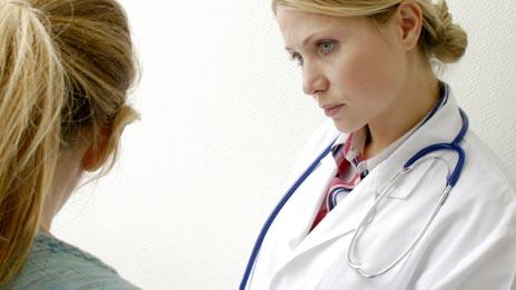 Doctor consoling a young woman