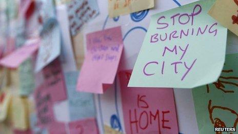 Post-It messages about last summer's riots such as "Stop burning my city"