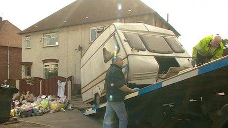 Caravan being taken from house