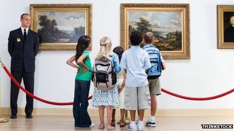 Security guard and children in a museum