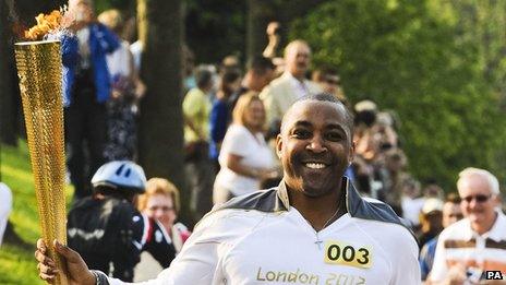 Olympic gold medallist, Darren Campbell carrying the flame on the leg between Worcester and Powick on Friday