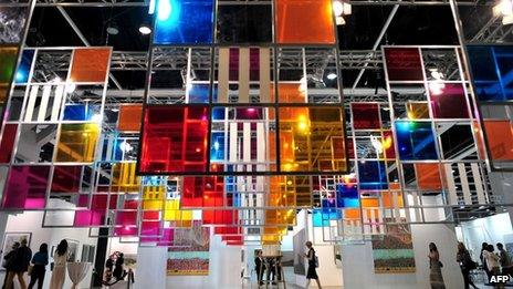 Visitors walk past art work at the Hong Kong International Art Fair in May, 2012