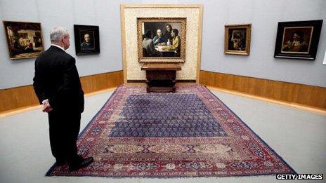 Visitor looking at Christ and Disciples of Emmaus (centre) and other paintings by Han van Meegeren (1889-1947) at the Boijmans Van Beuningen Museum in Rotterdam in 2010