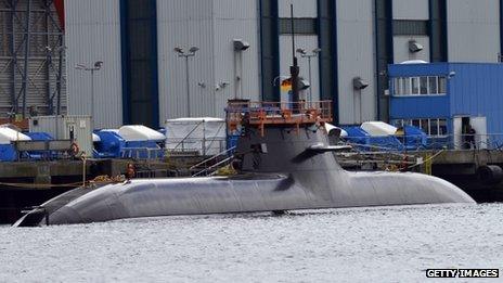 A Dolphin-class submarine anchors in front of docks of the Howaldts-Deutsche Werft (HDW) shipyard on Tuesday in Kiel, Germany