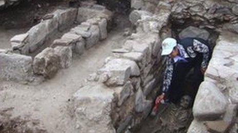 An archeologist is cleaning one of the skeletons unearthed during excavations in the Black Sea town of Sozopol, Bulgaria.