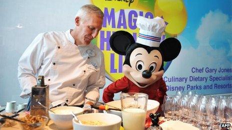 Mickey Mouse in front of a display for healthy food in Washington, DC 5 June 2012