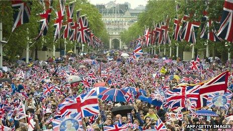 Crowds waving union jacks as they head down the Mall towards Buckingham Palace to celebrate the Queen's Diamond Jubilee in London on 5 June 2012. Photo: John MacDougall/AFP/Getty Images