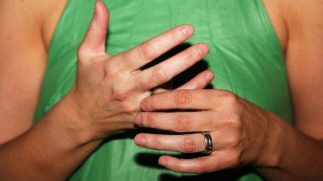 A woman wearing a wedding ring