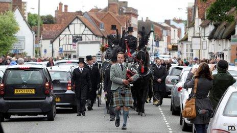 A lone piper leads the funeral procession of Bee Gee Robin Gibb