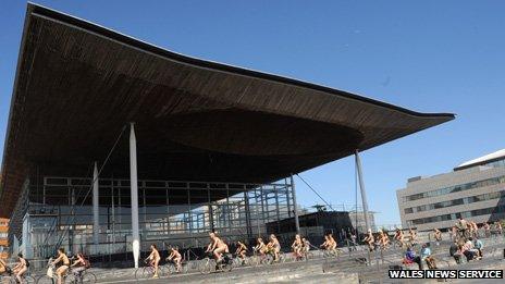 The riders alongside the Senedd building