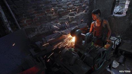 A mechanic works in a workshop in Mumbai