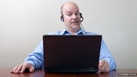 Man grimacing at computer screen