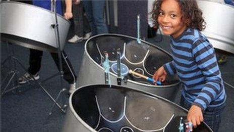 Child playing steel drums