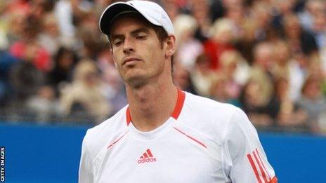 Andy Murray looks dejected as he is knocked out of Queens