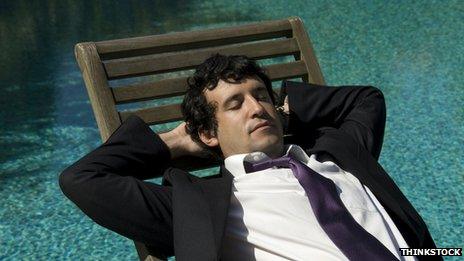 Man sunbathing in a suit