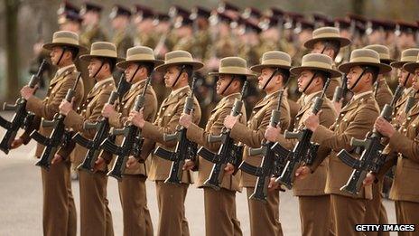 Soldiers in The Queen's Gurkha Engineers stand to attention